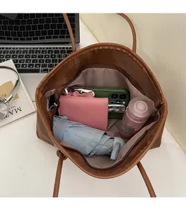 Top-down view of a spacious brown leather tote bag interior showing ample storage capacity