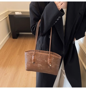 Detailed view of the coffee brown tote bag showing its vintage frosted leather texture