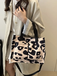 Large capacity canvas leopard print tote bag with black strap and front pockets for women