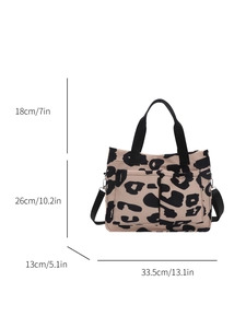Leopard print canvas tote bag with adjustable shoulder straps and front pockets