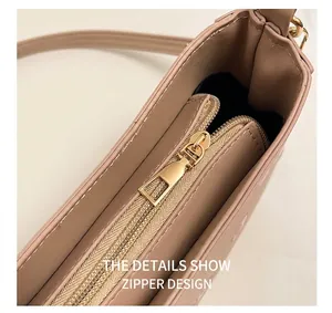 Detail shot of the smooth gold zipper closure and premium texture on cherry print bag