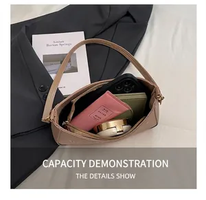 Top view of open beige baguette bag interior showing large capacity for daily essentials