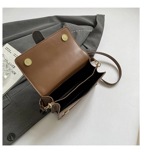 Detail view of brown leather bag interior with magnetic clasp and double compartments