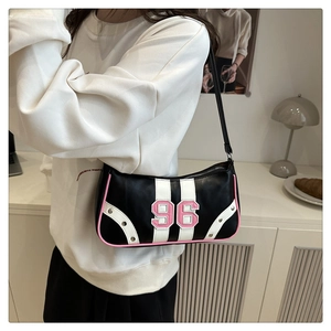 Close-up of black racing style bag with number 96 embroidery and pink trim accents