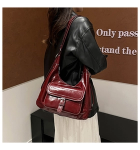 Burgundy faux leather shoulder bag with white contrast stitching and buckle detail