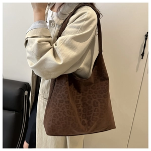 Detail of vintage leopard print tote bag in soft suede fabric with large interior capacity