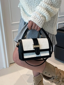 Elegant black and white leather handbag with geometric patterns and gold clasp for women