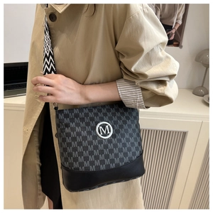 Détail du sac seau à motif jacquard M avec une large bandoulière géométrique