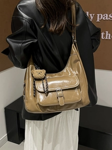 Stylish khaki shiny PU leather shoulder bag for women with stitch details and bear charm