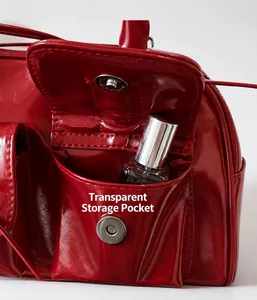 Detail of red patent leather shoulder bag featuring a side pocket with silver magnetic snap