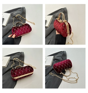 Detail of red velvet evening bag with quilted diamond pattern and sparkling crystal studs
