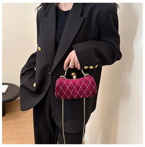 Detail of burgundy velvet evening bag with diamond lattice and pearl clasp closure