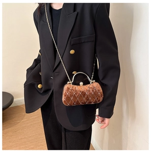 Brown velvet quilted clutch with gold handle and sparkling rhinestone ball lock detail