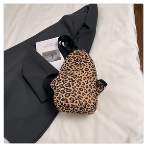 Detail of leopard print crossbody bag with black adjustable strap and D-ring hook hardware