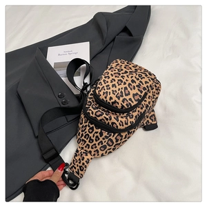 Detail of leopard print waist bag with multi-layer zippers and adjustable strap on a suit