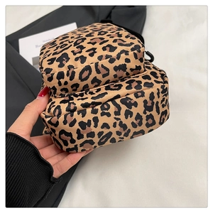 Close-up of leopard print fitness fanny pack with dual zipper pockets and black strap