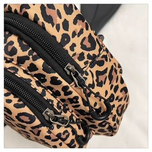 Macro view of leopard print bag featuring durable double zippers and nylon texture