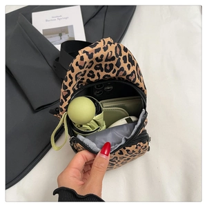Detail view of leopard print fitness fanny pack showing storage for phone and umbrella