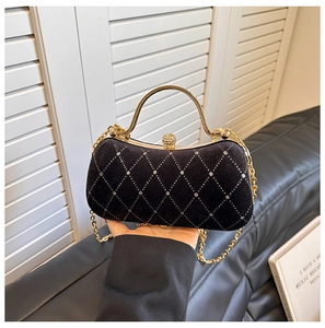 Detail of velvet evening bag with silver rhinestone lattice and gold clasp