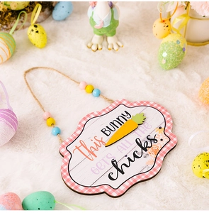 Close-up of Easter bunny wood sign with colorful beads and rustic plaid border decor