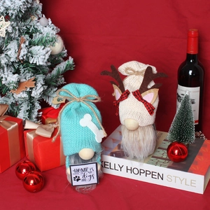 Two Christmas gnomes with knit hats and plush beards, festive holiday decor on red background