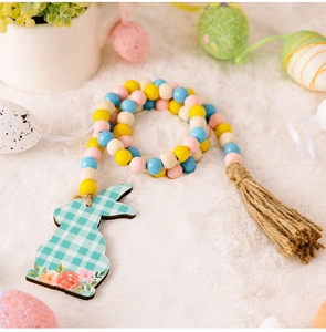 Close-up of Easter wood bead garland with green plaid rabbit charm and hemp rope tassel
