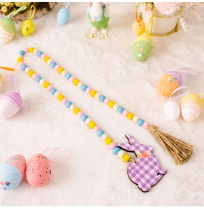 Close-up of Easter wooden bead garland with purple plaid bunny tag and jute tassel detail