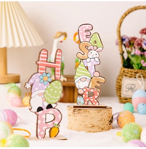 Close-up of Easter wood desk decorations featuring HOP and EASTER gnome bunny motifs