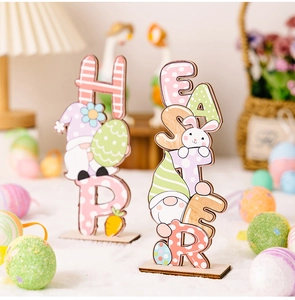 Macro view of colorful Easter wooden gnome and egg ornaments on soft white surface