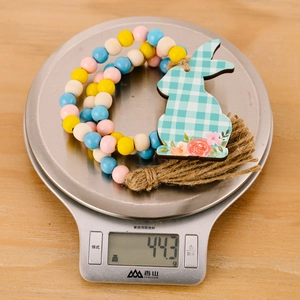 Easter bead garland with bunny wooden pendant and jute tassel on a scale showing 44.3g