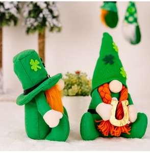 Detail of St. Patrick's Day gnomes with green shamrock hat and golden horseshoe mascot