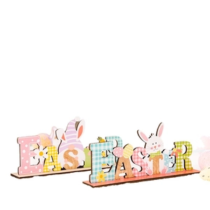 Colorful wooden Easter table ornaments with gnome and rabbit letters on white background