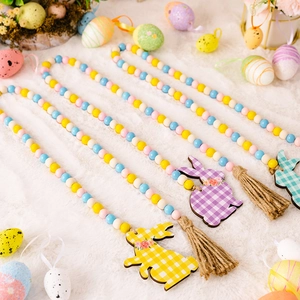 Easter wood bead garland with colorful rabbit pendants and tassels on white plush background