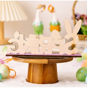 Detailed view of SPRING wooden Easter sign with rabbit ears and purple base on a desk