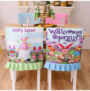Detailed view of Easter chair covers with gnome and rabbit prints on dining chairs
