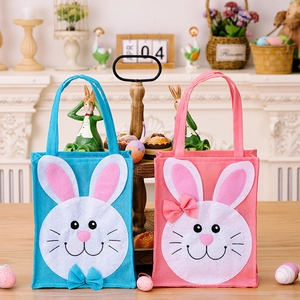 Close-up of pink and blue Easter bunny fabric gift bags with bow and floral textures