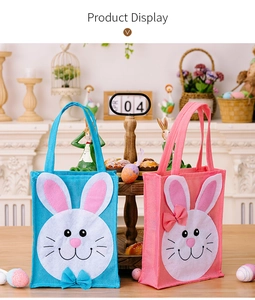 Close-up of Easter rabbit burlap gift bags in blue and pink with 3D bunny designs