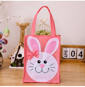 Detail of pink Easter bunny tote bag with cute 3D ears and bow on a festive wooden background