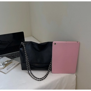 Close-up of black wrinkled leather bag with silver chain strap showing its medium size capacity
