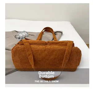 Detail showing the wear-resistant bottom design of the corduroy tote bag in brown
