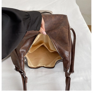 Close-up of the large interior compartment and fabric lining of the brown tote bag