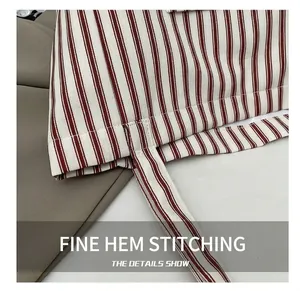 Close-up of precise stitching on red and white striped canvas tote bag with clean seam detail