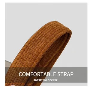 Close-up detail showing the textured brown corduroy shoulder strap of the tote bag