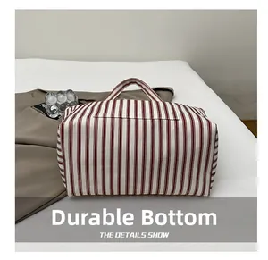 Detail shot of the wear-resistant bottom on this red striped canvas tote bag
