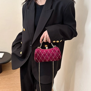 Elegant burgundy velvet evening clutch with diamond quilting and gold chain strap