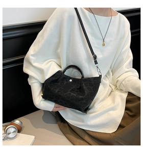 Detail of black leopard print tote bag with adjustable strap and matte texture