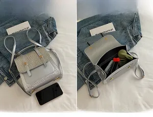 Detail of silver tweed backpack interior showing main compartment and storage capacity