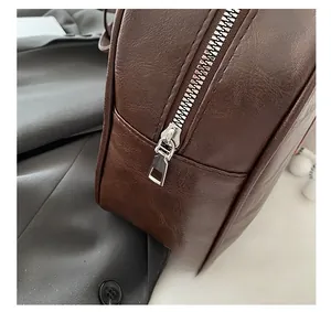Detail shot of the vintage brown faux leather bag with high-quality metal zipper close-up
