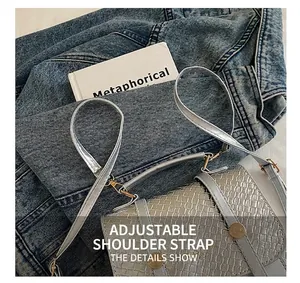 Detailed view of silver-grey woven texture on stylish bag with adjustable strap