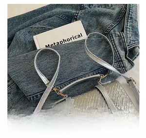 Detailed view of silver-grey woven texture on stylish bag with adjustable strap
